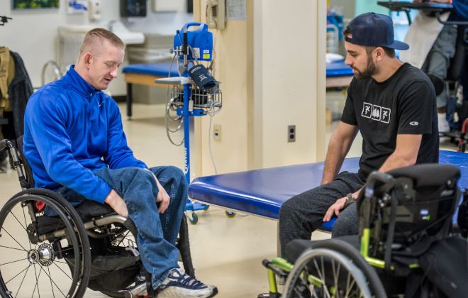 Peer support mentor meets with an outpatient with a spinal cord injury