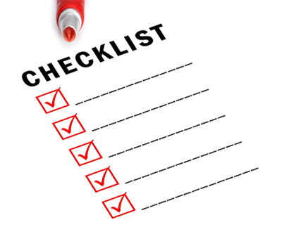 A piece of paper with "checklist" written at the top, red checked boxes, and a red pen at the top of the sheet