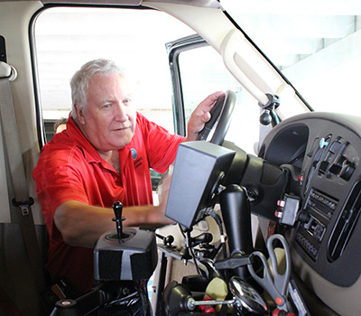  ClosePreviousNext Adapted Driving Program Driver rehabilitation specialist Jim Kennedy of Shepherd Center examines equipment in one of the hospital's adapted vehicles.