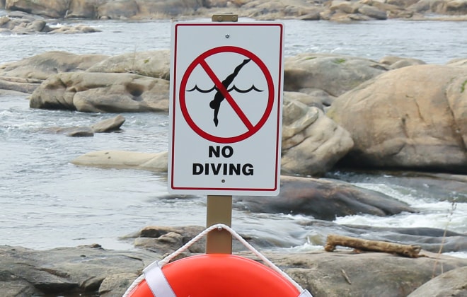 No Diving Sign next to lake
