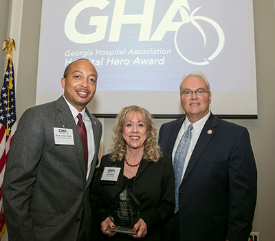 Montez Carter (left), F.A.C.H.E., Ann Boriskie, Shepherd Center Brain Injury Peer Visitor Association Director and recipient of the Hospital Hero Award, and Earl Rogers (right), Georgia Hospital Association President and CEO.