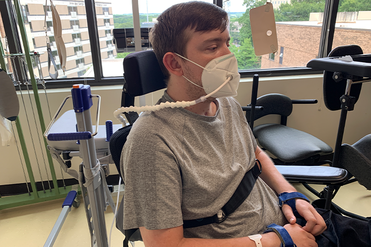 Spinal cord injury patient with limited upper extremity function demonstrates how the sip-and-puff device works with a modified KN95 mask.