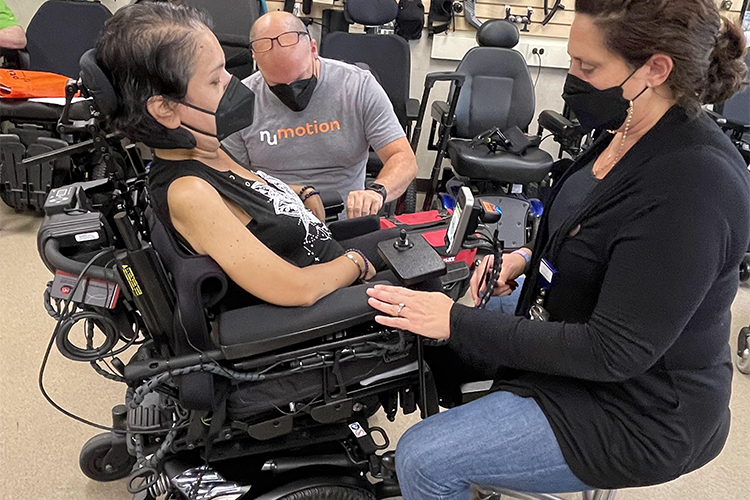 A patient at Shepherd Center consults with wheelchair specialists during a personalized wheelchair evaluation session.