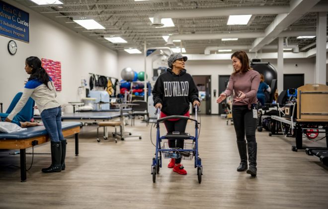 MS rehabilitation patient walks alongside her physical therapist while doing therapy for MS at Shepherd Center