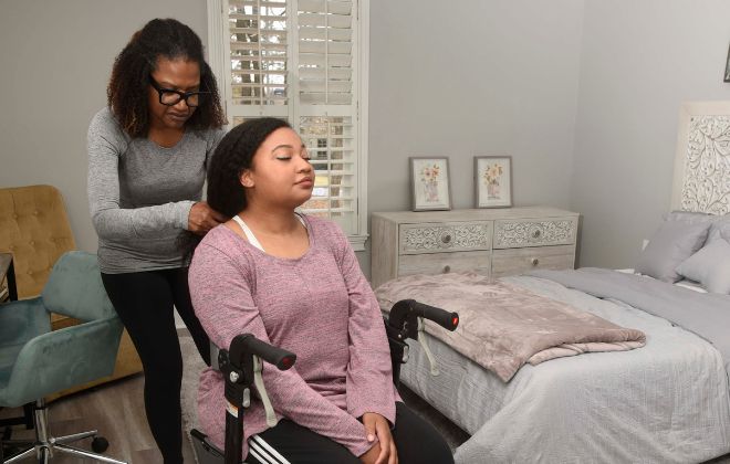MS rehabilitation patient uses occupational therapy to help with brushing her hair