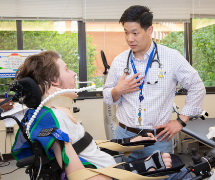 Dr. Wesley Chai meets with a patient in the Comprehensive Rehabilitation Unit.