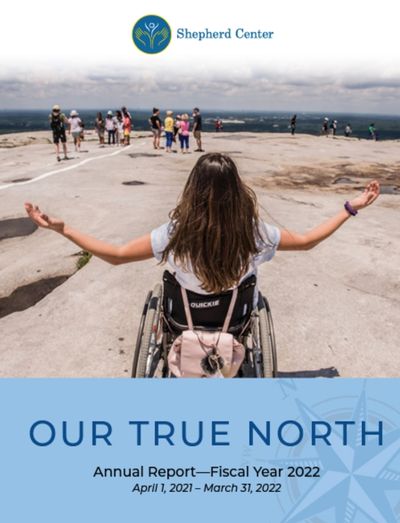Woman sitting in a wheelchair with arms out to her side on top of a mountain. Underneath are the words, &quot;Out True North: Annual Report - Fiscal Year 2022, April 1, 2021 - March 31, 2022.&quot;