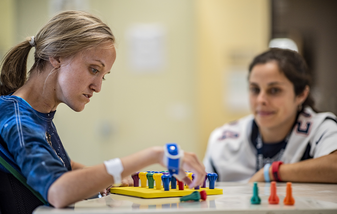 Spinal cord injury patient works with clinical psychologist during a therapy session