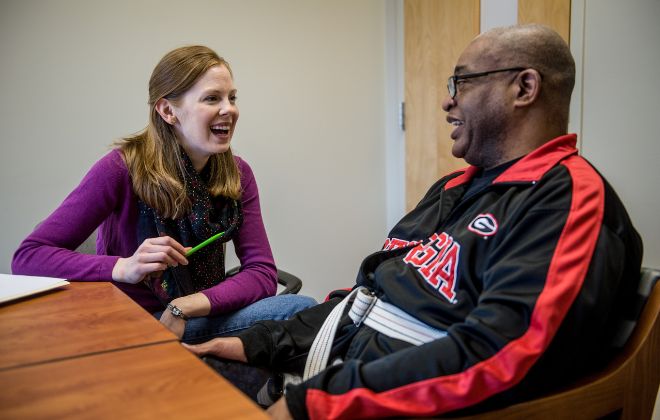 Patient smiles as he discusses his care plan with his case manager at Shepherd Center