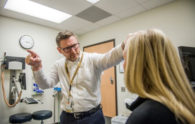 Russell Gore, M.D., evaluates a patient in the Complex Concussion Clinic at Shepherd Center