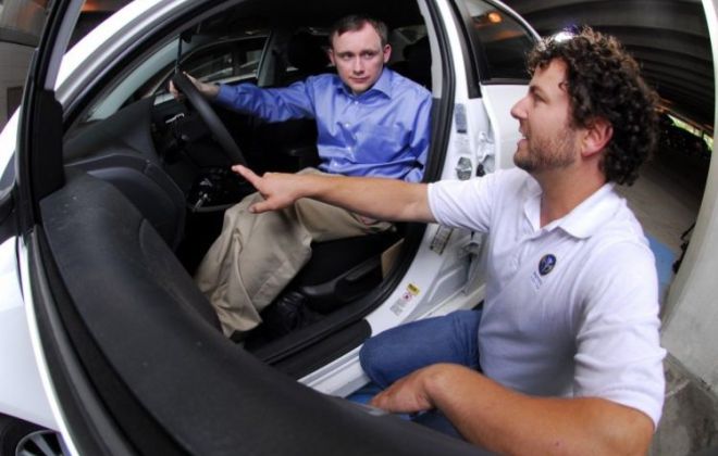Occupational therapist Matt Abisamra, right, reviews driving precautions with a Shepherd Center client.
