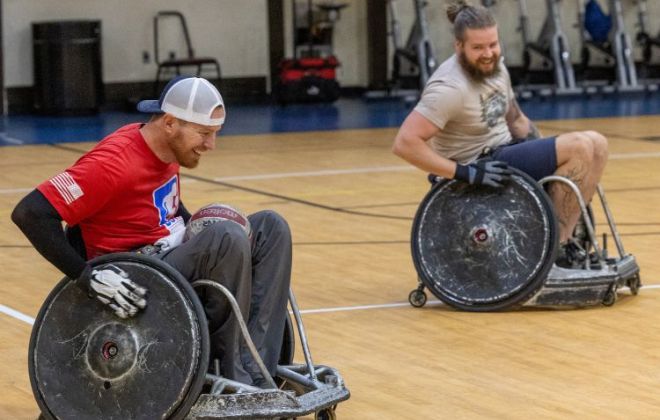 Patient Travis Daniel practices wheelchair rugby in the gym with assistant coach Jonny Rea as part of the Shepherd Smash rugby team.
