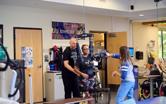 Patient at Shepherd Center utilizes the ZeroG system to incorporate boxing into her rehabilitation, aiding in recovery of walking and balance skills after a brain injury.