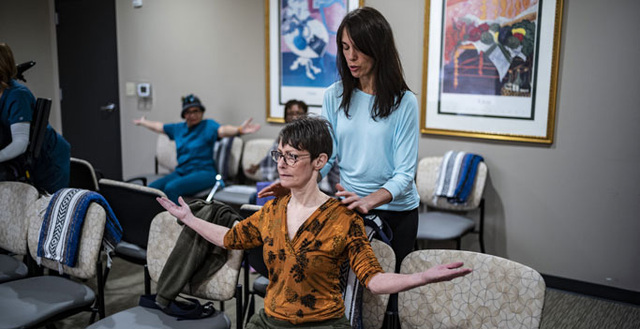 Multiple sclerosis patients participate in a yoga class offered at the MS Institute of Wellness Program.