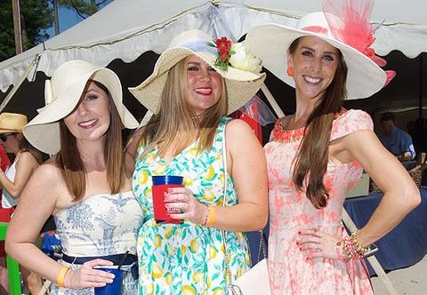 Group of three women in summer hats and dresses at Shepherd Center's annual Derby Day event