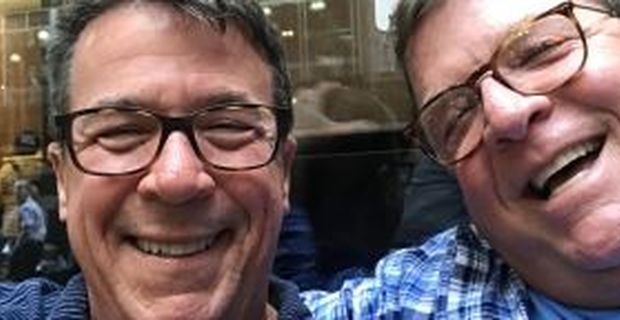 Bill Henis smiles with his husband, Kevin
