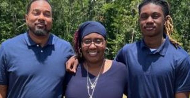 Felicia Trammell smiles with her husband and son