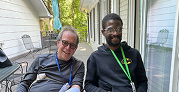 Richard Zane and Kenny Freeman smile while seated together at Shepherd Pathways