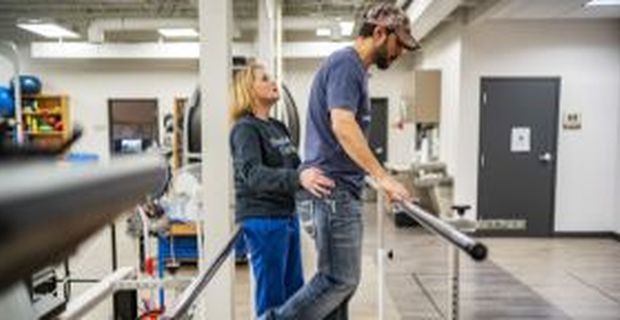 Physical therapist from MS Institute helps patient work on their balance