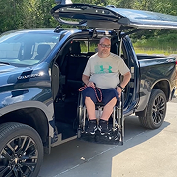 Ben Elstad shows off his wheelchair accessible pickup truck which includes batwing doors and a wheelchair lift.