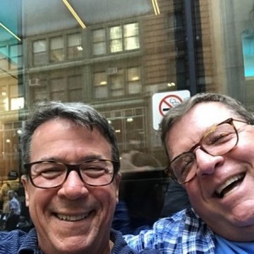 Bill Henis smiles with husband Kevin